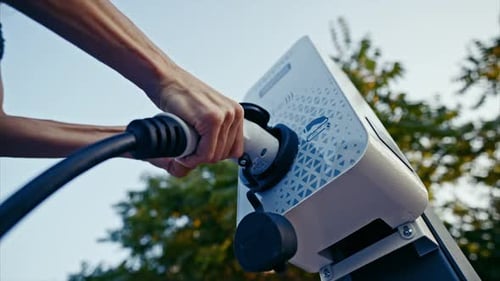 Sustainable Energy Future Charging Electric Vehicle at Modern Power Station