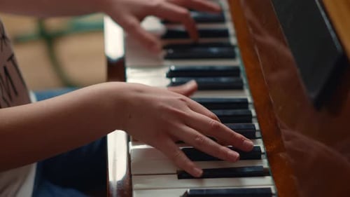Child plays piano at home in the daytime