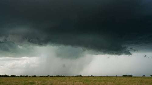 Severe Stormy Weather Over Grassy Field in the Countryside