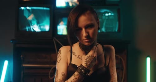 Young Woman with Tattoos Posing in Edgy Home Setting