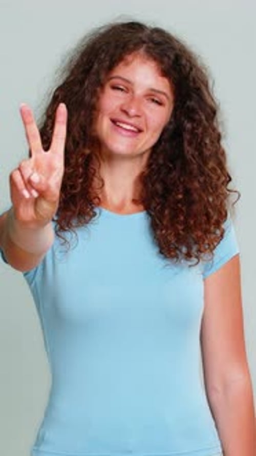 Smiling Woman Showing Peace Sign