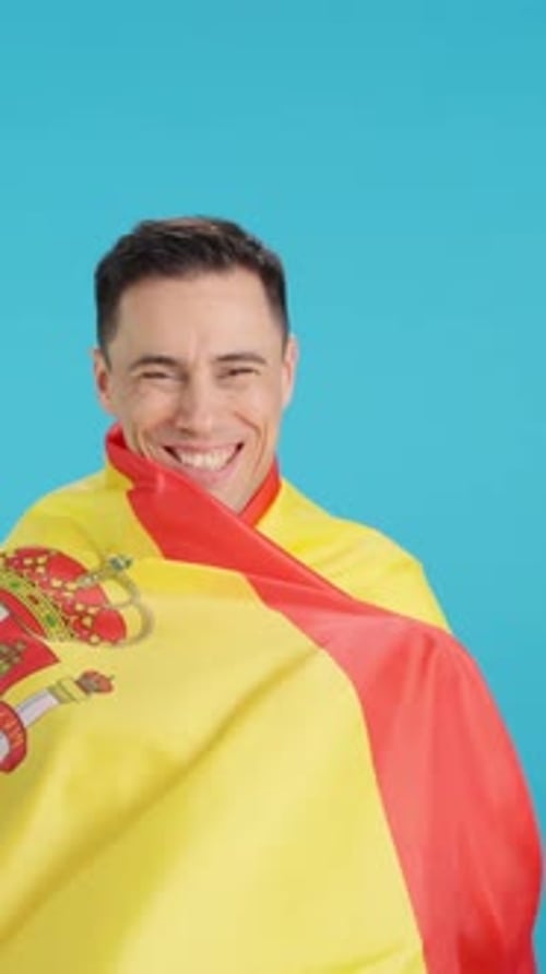 Enthusiastic Man Wrapped in a Bright Flag