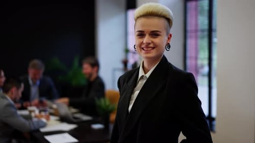 Confident Businesswoman Smiling in Modern Office Setting