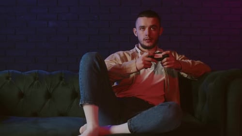 Man Relaxing Playing Video Games on Couch