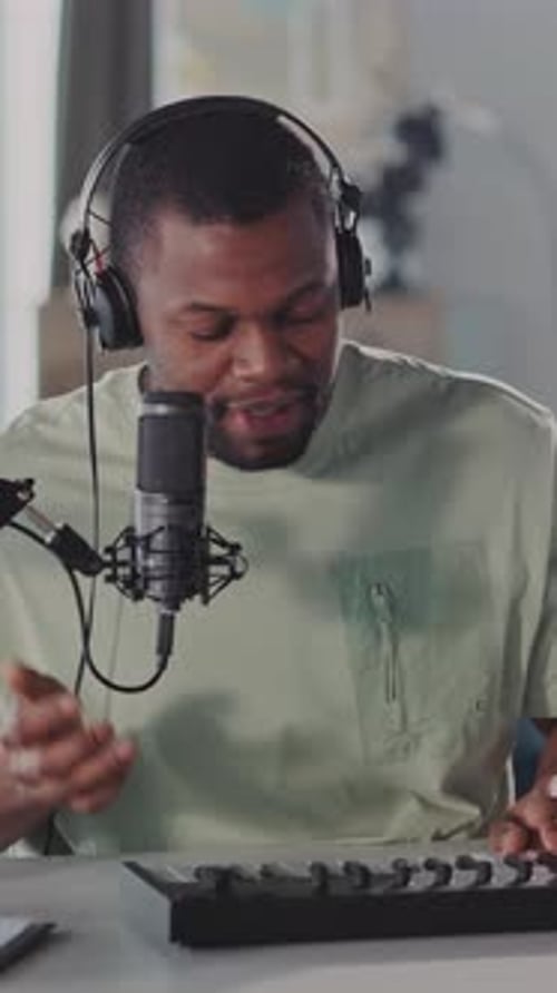 Man Singing and Playing Keyboard in Home Studio