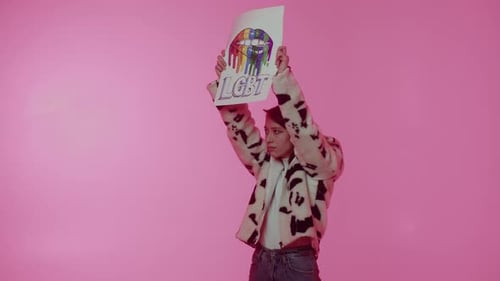 Young Adult Holds Up LGBT Pride Rights Sign