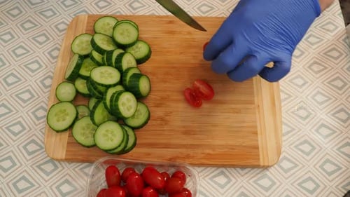 Slicing Fresh Cucumbers and Tomatoes for Salad