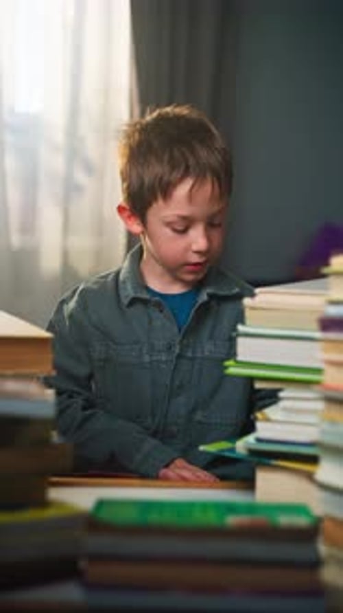 Schoolboy Studying at Home with a Book in Hand Preparing for School