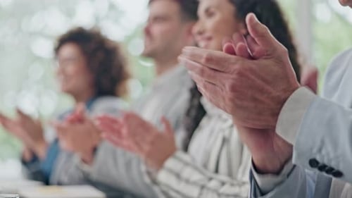 Colleagues Applauding at Business Conference