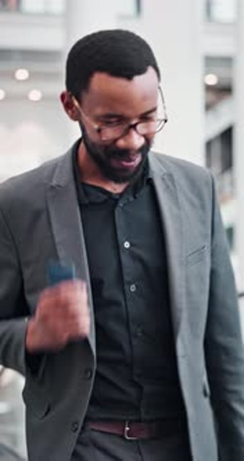 Smiling Man Uses Smartphone In Modern Office
