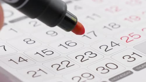 Marking Important Date on Wall Calendar With Pen
