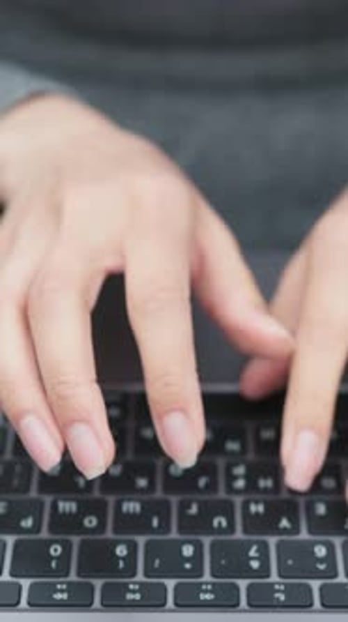 Woman Typing on Laptop Keyboard Close Up