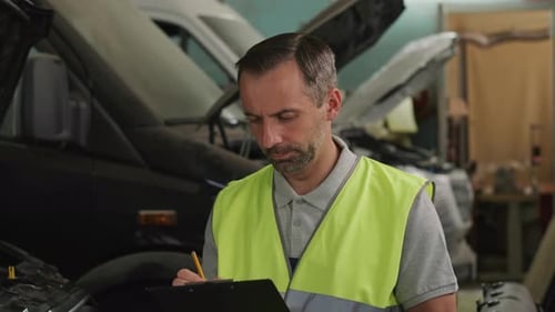 Portrait of Middle Aged Mechanic at Car Service