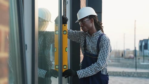 Professional African American Builder Using Spirit Level