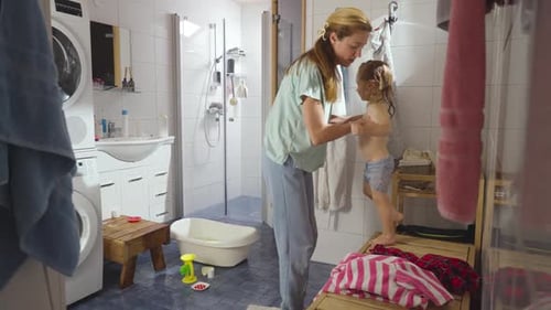 Mother and Child Playfully After Bath Time