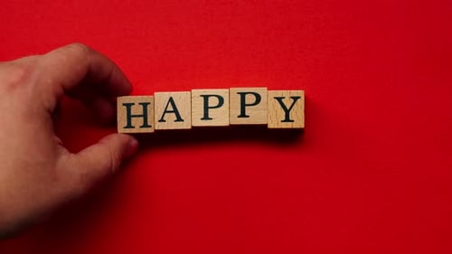 Happy Message Spelled Out with Wooden Blocks