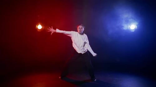 Young Adult Dancing in a Studio with Stage Lighting