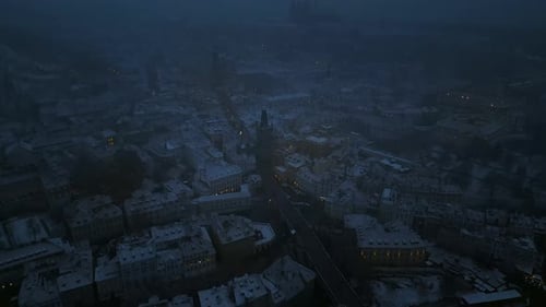 Aerial drone view of the Old Town square covered in snow in the night. Winter in Prague, Czech Repub