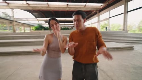 Happy Man and Woman Dancing Outdoors