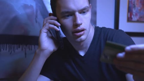 Young Adult on Phone with Credit Card