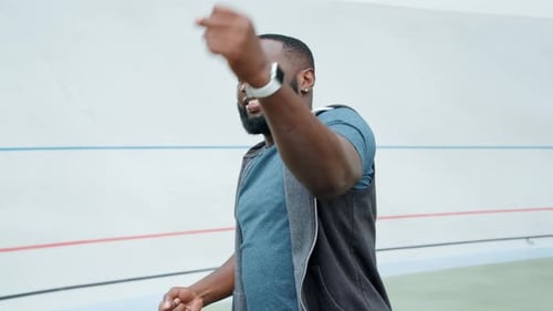 Portrait Of Fitness Sportsman Warming Hands On Stadium Track In Slow Motion. African American Man...