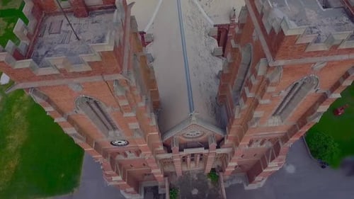 A beautiful old Church top close up aerial view, Red building of the Church, Green trees and grass a