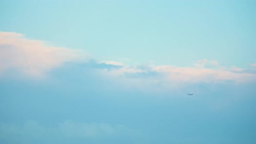 Flying plane in a stormy weather, blue sky, surfing clouds, video