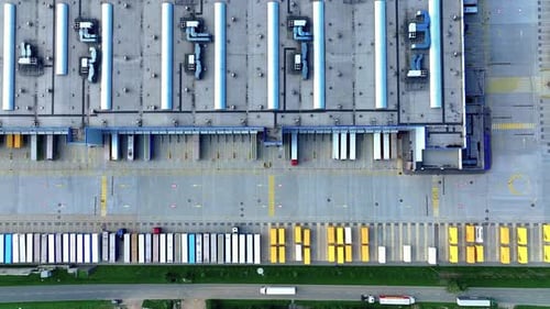 Aerial view of a distribution center with loading docks and trucks