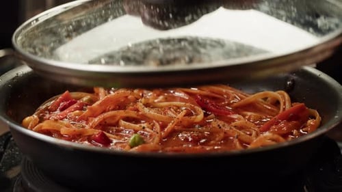 Cooking Pasta with Tomato Sauce in a Pan