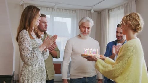 Family Celebrates Birthday with Cake and Applause