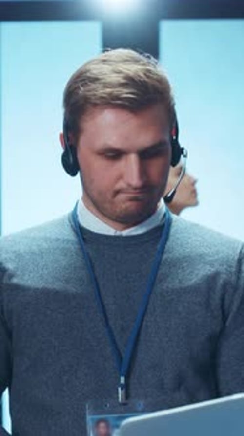 A Dedicated and Focused Male Call Center Agent Working in a Modern Office Environment