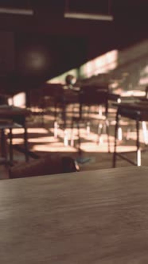View to Classroom with Tables and Small Blackboard and Grungy Walls