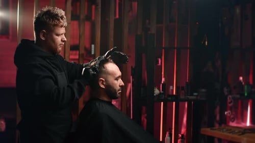 Barber Giving Man Haircut in Warmly Lit Shop