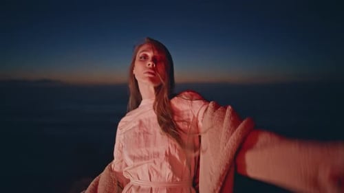 Woman Posing in White Dress and Jacket at Dusk