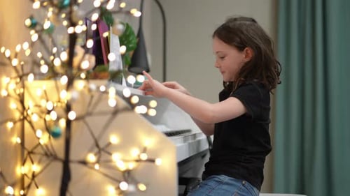 Young Girl Playing Piano at Home