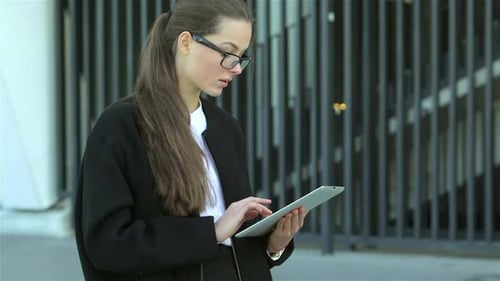 Woman Using Tablet and Giving Thumbs Up