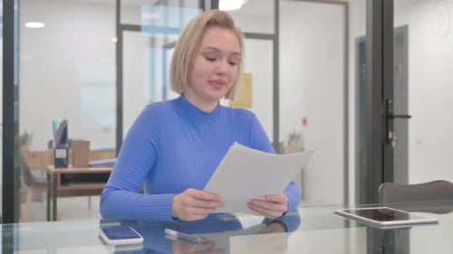 Woman Reads Document at Modern Meeting Table