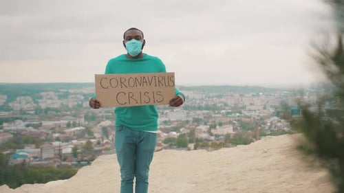 Man with Mask Holding Coronavirus Crisis Sign