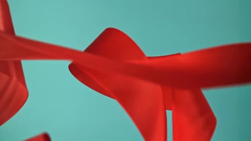 Abstract Red Ribbons Floating on Light Blue Background