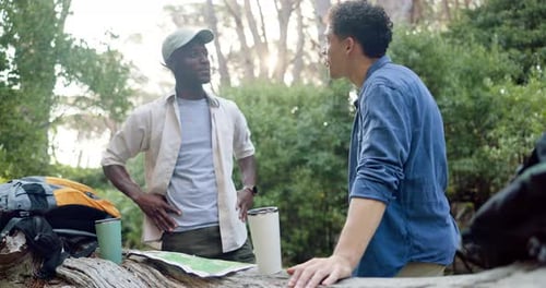Men, friends and map in forest for hiking, journey and pointing in direction