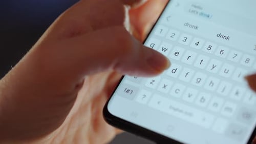 Hands Typing Message on Smartphone Keyboard Close Up