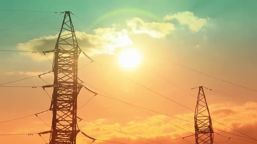 Electrical Pylons Silhouetted Against Vibrant Sunset