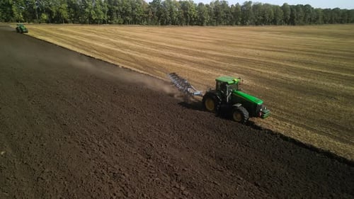 Tractors plowing the field in Ukraine