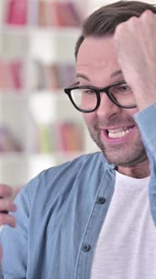 Man in Glasses Smiling and Using Mobile Phone