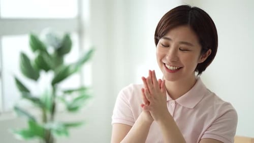 Smiling Woman Clapping Her Hands Indoors