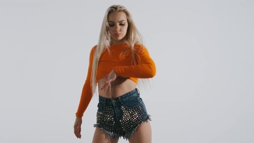 Blonde Woman Dancing in Fashionable Outfit