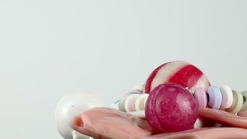 Isolated against a simple white backdrop, a tempting portion of kid's candy rotates slowly