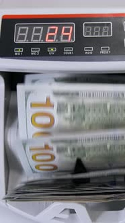 Automatic money counting in the machine. Electronic money machine is counting the dollar banknotes