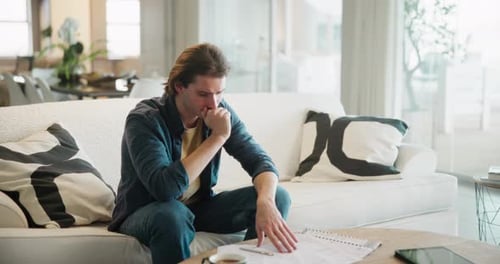 Home, man and college student stress with document on sofa with exam, anxiety