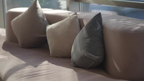 Comfortable Couch with Pillows in Sunlight